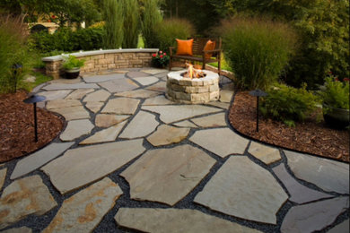 Patio - mid-sized traditional backyard stone patio idea in Cincinnati with a fire pit