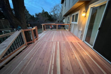 Deck - large traditional backyard ground level privacy and mixed material railing deck idea in Denver with no cover