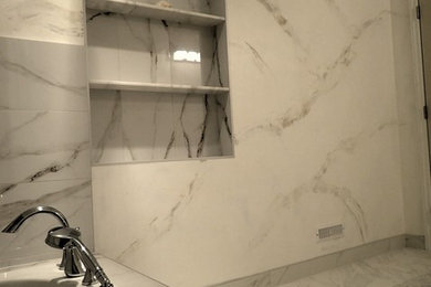 Mid-sized transitional 3/4 white tile and stone slab marble floor and white floor bathroom photo in Ottawa with beaded inset cabinets, white cabinets, white walls, an integrated sink and solid surface countertops