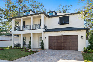 Large contemporary white two-story house exterior idea in Tampa