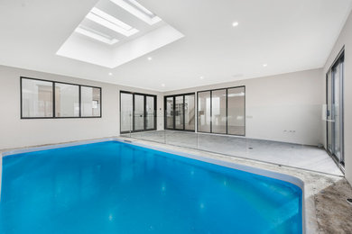 Photo of a mid-sized modern indoor rectangular lap pool in Melbourne.