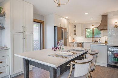 Inspiration for a mediterranean eat-in kitchen remodel in Charlotte with an undermount sink, shaker cabinets, white cabinets, quartzite countertops, white backsplash, subway tile backsplash, stainless steel appliances and white countertops