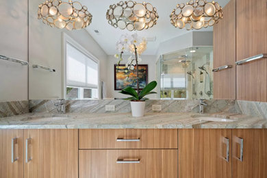 Example of a large trendy master travertine floor and double-sink bathroom design in Chicago with flat-panel cabinets, light wood cabinets, quartzite countertops and a built-in vanity