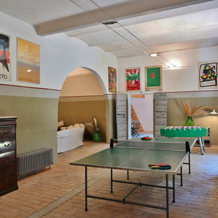 Inspiration for a large contemporary basement in Other with multi-coloured walls, brick flooring and pink floors.