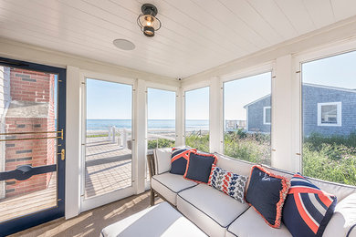 Inspiration for a mid-sized beach style sunroom in Boston with medium hardwood floors, no fireplace, a standard ceiling and brown floor.