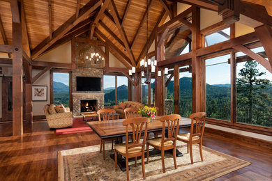 Example of a mountain style dark wood floor great room design in Denver with beige walls