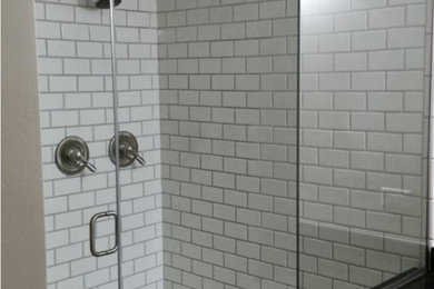 Mid-sized transitional 3/4 white tile and subway tile ceramic tile and brown floor alcove shower photo with shaker cabinets and a hinged shower door