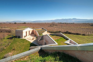 Inspiration for a large contemporary split-level stucco exterior home remodel in Madrid