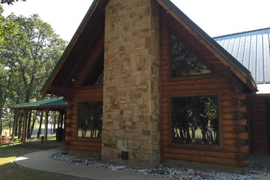Large rustic brown one-story wood gable roof idea in Austin