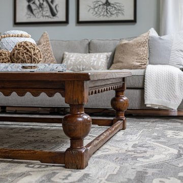 Neutral Two Story Family Room with Tufted Wing Chairs