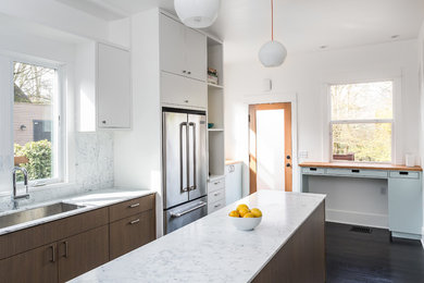 Mid-sized modern l-shaped kitchen in Seattle with an undermount sink, flat-panel cabinets, dark wood cabinets, marble benchtops, white splashback, stone slab splashback, stainless steel appliances, dark hardwood floors and with island.