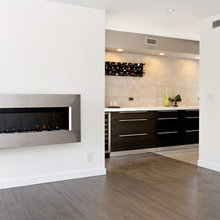 fireplace, cabinets and stainless base trim