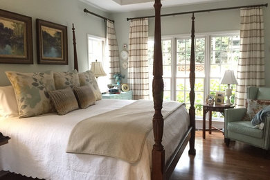 Inspiration for a traditional master bedroom in Other with blue walls and medium hardwood floors.