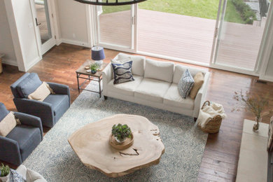 Example of a large transitional open concept dark wood floor and brown floor living room design in Other with gray walls, a standard fireplace, a stone fireplace and a media wall