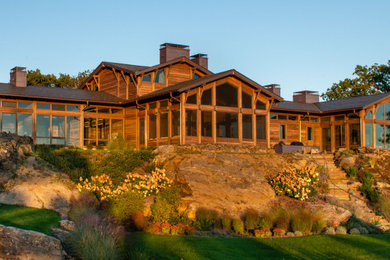 Example of a huge mountain style brown mixed siding exterior home design in Bridgeport with a green roof and a gray roof