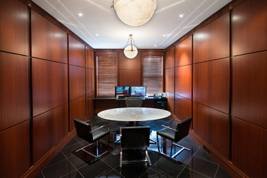 Example of a large minimalist built-in desk porcelain tile and black floor study room design in Philadelphia with brown walls and no fireplace