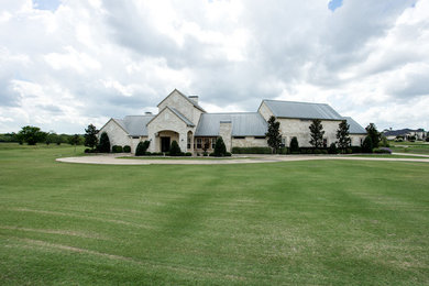 Photo of a country home design in Dallas.