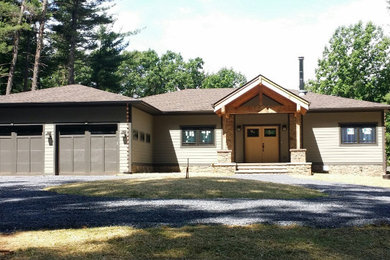 Arts and crafts brown two-story concrete fiberboard house exterior photo in DC Metro with a hip roof and a shingle roof