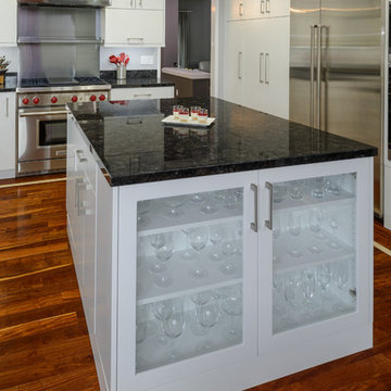 White Kitchen Island with Black Countertop and Glass Paneled Cabinet