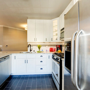 White Kitchen Remodel with Colonial White Granite and Stainless Steel Appliances