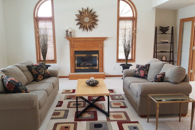 This is an example of a mid-sized traditional formal enclosed living room in Other with white walls, carpet, a standard fireplace, a wood fireplace surround, no tv and white floor.