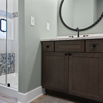 Warm and Cohesive Multi-Bathroom Design In Nokesville