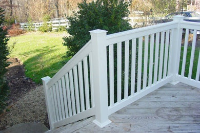 Example of a mid-sized classic backyard deck design in Other