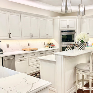 Ivory White Kitchen With Marble Look Quartz Counters and Splash
