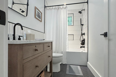 Bathroom - small transitional white tile and ceramic tile ceramic tile, black floor and single-sink bathroom idea in New York with recessed-panel cabinets, medium tone wood cabinets, a one-piece toilet, white walls, an undermount sink, quartzite countertops, gray countertops and a freestanding vanity