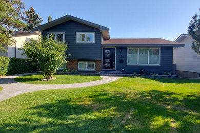 Inspiration for a large timeless gray split-level concrete fiberboard house exterior remodel in Calgary