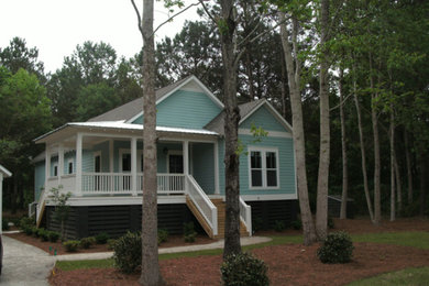 Small cottage blue one-story wood house exterior photo in Orlando with a hip roof and a mixed material roof