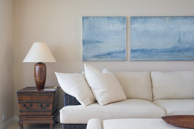 Living room - small contemporary formal and open concept limestone floor living room idea in Hawaii with beige walls and a media wall