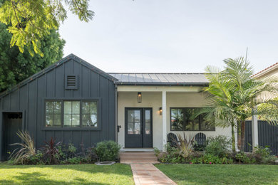 Example of a mid-sized farmhouse exterior home design in Los Angeles