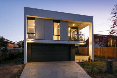 This is an example of a large modern two-storey concrete white house exterior in Canberra - Queanbeyan.