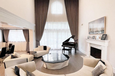 Living room - large contemporary light wood floor, brown floor and tray ceiling living room idea in Los Angeles with white walls, a standard fireplace and a stone fireplace