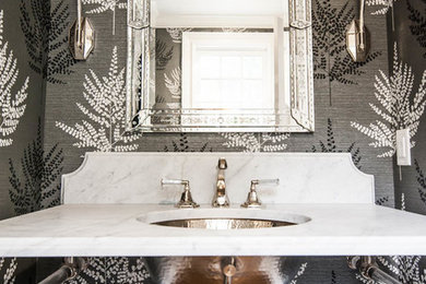 Inspiration for a small transitional dark wood floor powder room remodel in New York with a two-piece toilet, multicolored walls, an undermount sink, marble countertops, open cabinets and white countertops