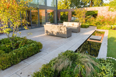 Photo of a large contemporary backyard garden in Other with natural stone pavers.