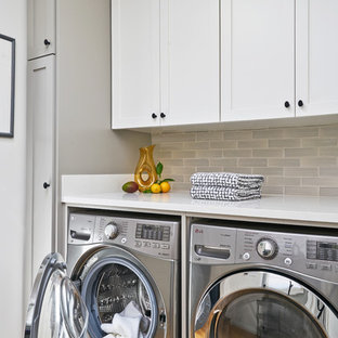 Traditional utility room in Los Angeles with shaker cabinets, white cabinets, engineered stone countertops, a side by side washer and dryer, white worktops, medium hardwood flooring and brown floors.