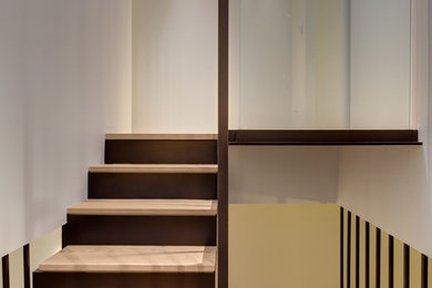 Photo of a small modern wood u-shaped staircase in Sydney with metal risers.