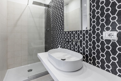 Inspiration for a large contemporary 3/4 bathroom in Milan with a corner shower, white tile, ceramic tile, grey walls, porcelain floors, a vessel sink and marble benchtops.