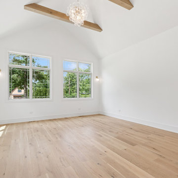 Bright Vaulted Living Space with Beamed Ceiling and Crystal Lighting