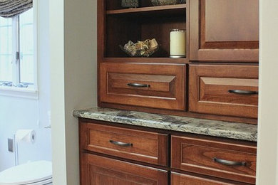 Mid-sized transitional master gray tile and ceramic tile ceramic tile alcove shower photo in Philadelphia with blue walls, an undermount sink, raised-panel cabinets, dark wood cabinets, a one-piece toilet and granite countertops