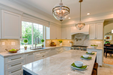 Example of a transitional beige floor kitchen design in San Francisco with an undermount sink, recessed-panel cabinets, white cabinets, stainless steel appliances, an island and beige countertops