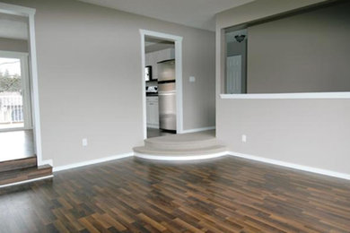 This is an example of a living room in Other with dark hardwood floors.