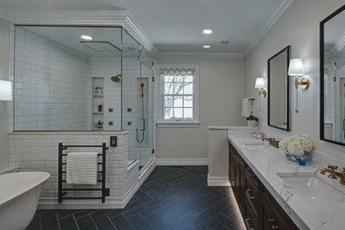 Example of a large transitional master ceramic tile, black floor and double-sink corner shower design in Chicago with medium tone wood cabinets, an undermount sink, quartz countertops, a hinged shower door, gray countertops, a niche and a freestanding vanity