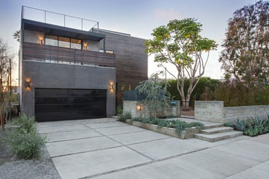 Inspiration for a contemporary two-storey exterior in Los Angeles with wood siding and a flat roof.