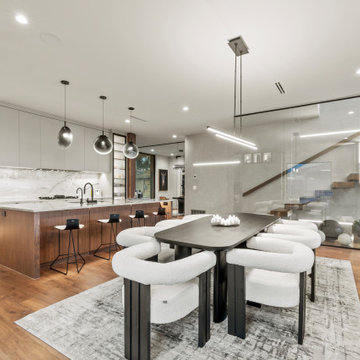 Modern Luxury Lakehouse Open-Concept Kitchen, Dining, and Floating Staircase Beh