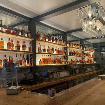 North of Bourbon booth barrels, bar and floors