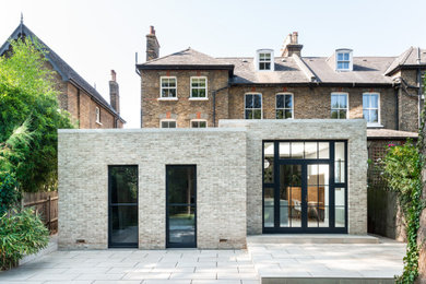 Inspiration for a traditional house exterior in London with a flat roof.