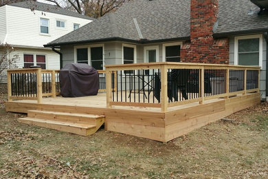 Photo of a large traditional backyard deck in Kansas City with no cover.